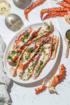 Delicious crab legs garnished with fresh herbs and garlic serve as the focal point of this mouth-watering dish. Paired with white wine.