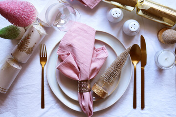 Christmas Dinner Table Setting in Modern Pink, White and Gold Theme, Close Up.