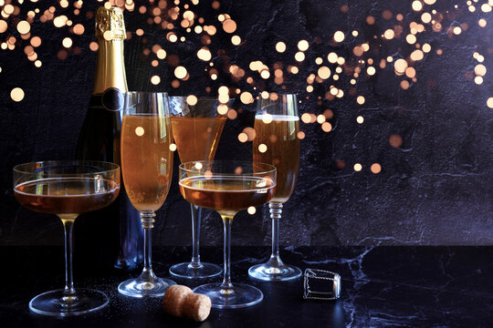 Champagne Celebration on Dark Background with Bokeh Lights, with Negative Space.