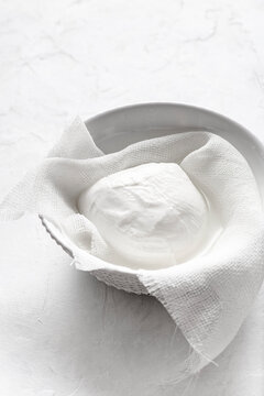Italian mozzarella cheese in a bowl. Front view.