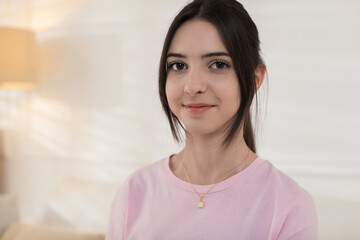 Portrait of beautiful teenage girl at home
