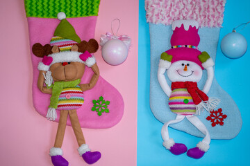 Boy or girl? gender reveal party, blue and pink balls on santa socks background. Christmas gender reveal, winter baby