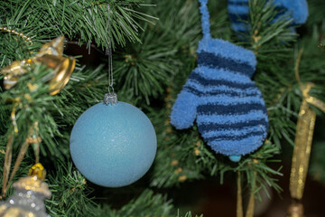 it is a boy. christmas tree decorated with blue ball bauble by pregnant women expecting baby boy son. blue glove