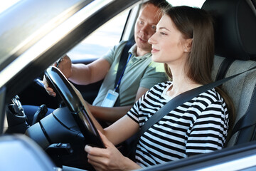 Driving school. Student passing driving test with examiner in car