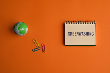 There is notebook with the word Greenwashing. It is as an eye-catching image.