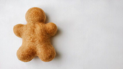 A fluffy, golden gingerbread man, crafted using needle felting technique and has soft and rounded shape, fastive background.