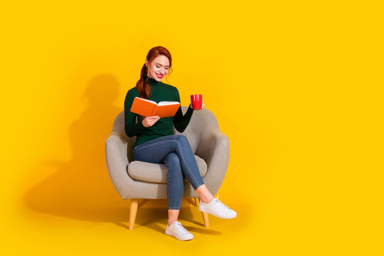 Full length photo of charming positive woman wear green turtleneck sitting sofa enjoy book empty space isolated yellow color background