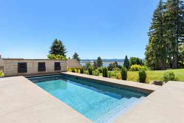 Outdoor pool in backyard of new luxury home