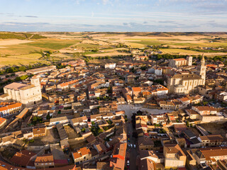 Fototapeta premium Scenic view from drone of Medina de Rioseco residential areas with medieval churches in sunny summer day