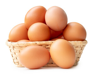 Group of fresh brown chicken eggs in stack in wicker basket isolated on white background with clipping path