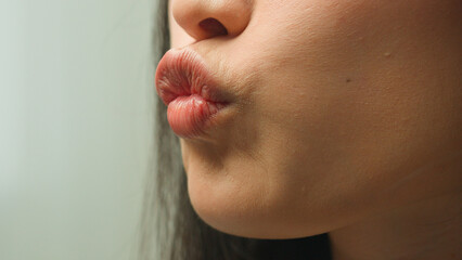 Close up female beautiful unrecognizable sexy woman Asian girl mouth details extreme lips air kiss love affection flirt kissing makeup lipstick cosmetology beauty injection healthy skincare face part