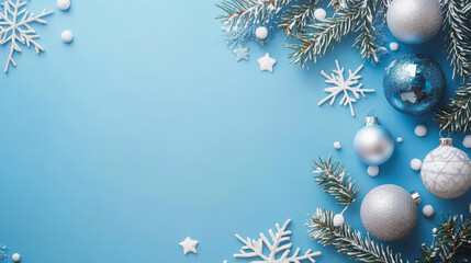 Festive Christmas background featuring blue and silver ornaments, snowflakes, and pine branches, creating cheerful holiday atmosphere