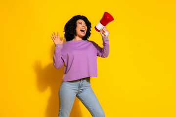 Photo of nice young woman loudspeaker empty space wear purple pullover isolated on yellow color background