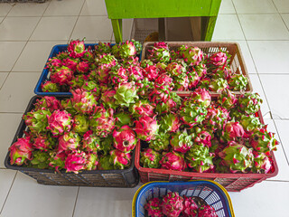 Dragon fruits are of the cactus genus Hylocereus and Selenicereus. A pile of red dragon fruits in a...
