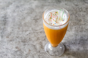 a glass of mango-flavored smoothie