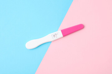 One pregnancy test on color background, top view