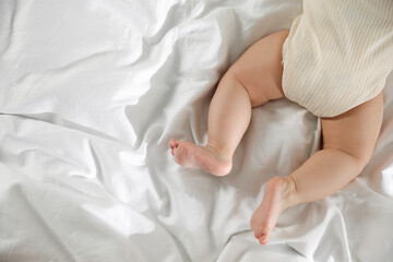 Cute little baby on bed indoors, top view. Space for text