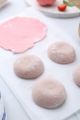 Tasty homemade mochi and dough on table, closeup