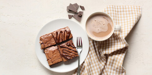 Plate with chocolate brownie pieces and cup of coffee on white background