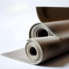 A yoga mat rolled up neatly on a white background 3