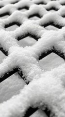 Close-up view of a chain-link fence blanketed in fresh snow, highlighting winters tranquility
