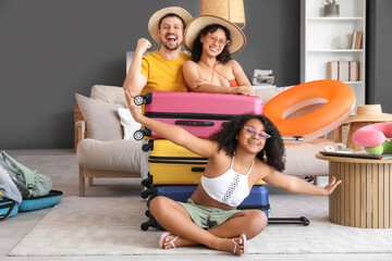 Happy family with packed suitcases at home. Travel concept