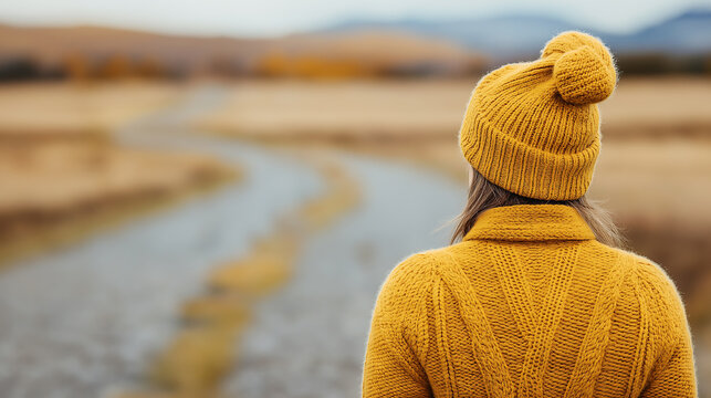 A person standing in an open field with a local road in the morning, ready to embrace new possibilities, symbolizing fresh air and new beginnings