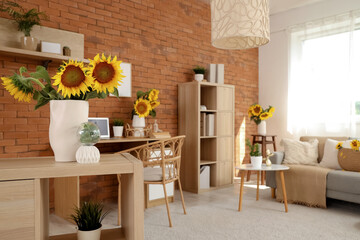 Vase with bouquet of beautiful sunflowers on wooden shelf in stylish living room