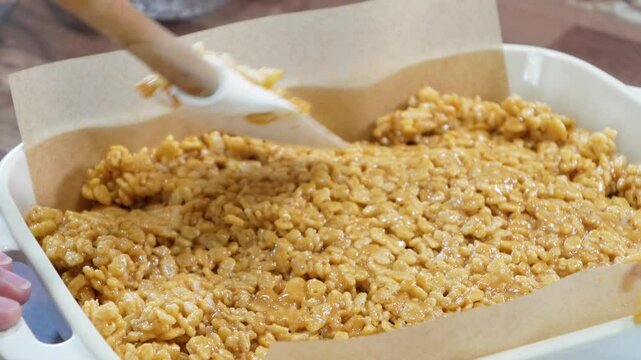 Baking rice krispy treats with butterscotch and chocolate on top. Fun chocolate sweet treats for grown ups and kids.  Chocolate rice krispy treats.