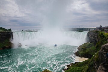 Tourist ferry at the base of the Niagara Falls on the Niagra River, Ontario, Canada.