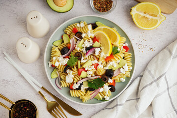 Plate with traditional pasta salad on table