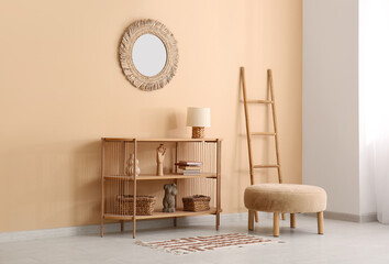 Shelving unit, pouf and mirror in interior of living room