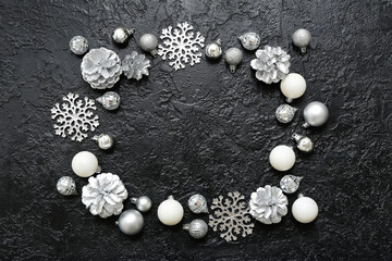 Frame made of Christmas balls, decorative snowflakes and cones on black background