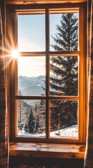 A scenic view of snow-covered mountains and trees through a wooden window at sunrise.