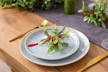 Christmas table setting with mistletoe, closeup