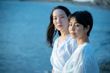 Portrait of Two Women by the Ocean at Dusk