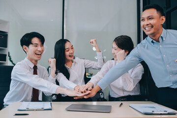 Group of business workers standing with hands together at the office