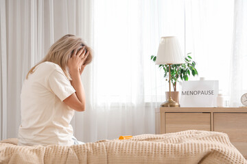Mature woman experiencing menopause in bedroom