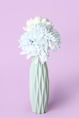 Vase with beautiful chrysanthemum flowers on lilac background