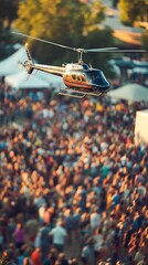 A helicopter hovers above a large crowd at an outdoor event.
