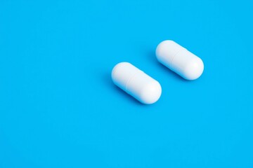 White Capsules on Blue Background.generative AI
