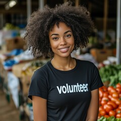 Beautiful young African-American woman wearing a volunteer shirt posing in front of a food bank.