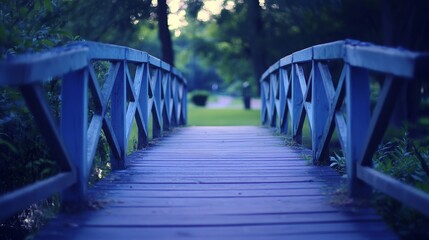 Serene Wooden Bridge Over Tranquil Park Pathway Surrounded by Lush Greenery and Soft Evening Light in a Peaceful Outdoor Environment