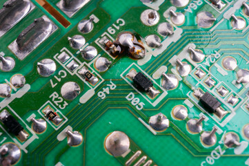 The back side of an electronic circuit board with connecting tracks close-up