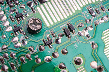 The back side of an electronic circuit board with connecting tracks close-up