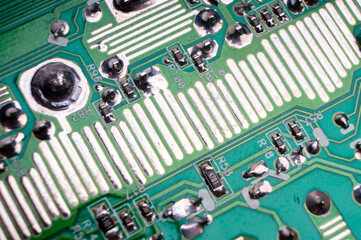 The back side of an electronic circuit board with connecting tracks close-up