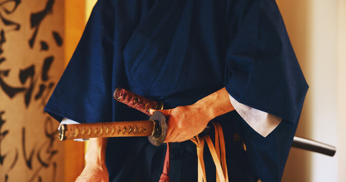 Japan, martial arts and hands of samurai with sword for self defense, combat or protection in battle. Sensei closeup, person and weapon in sheath for routine practice, cultural discipline or kenjutsu