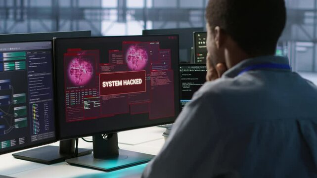 Engineers seeing system hacked popup on PC screen in data center, requesting help from cybersecurity team. Server farm worker seeing security incidents affecting network system, camera A