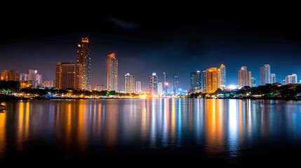 Obraz premium Stunning Nighttime Cityscape Over Calm Waters, Showcasing Bright Lights, Modern Skyscrapers, Reflections, and Vibrant Urban Atmosphere in a Beautiful Urban Environment