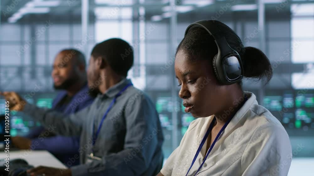 Poster portrait of smiling engineer hearing podcasts to make time pass faster while working in server farm 